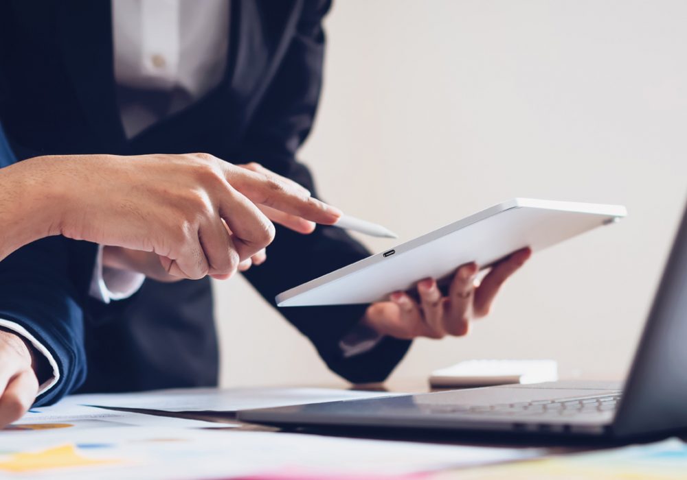 Business team using tablet and laptop computer to work in the office. proportion of the banner for ads.